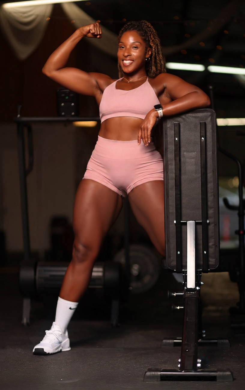 Bobbi, BodiedxBobbi fitness instructor, in a sunlit pink studio